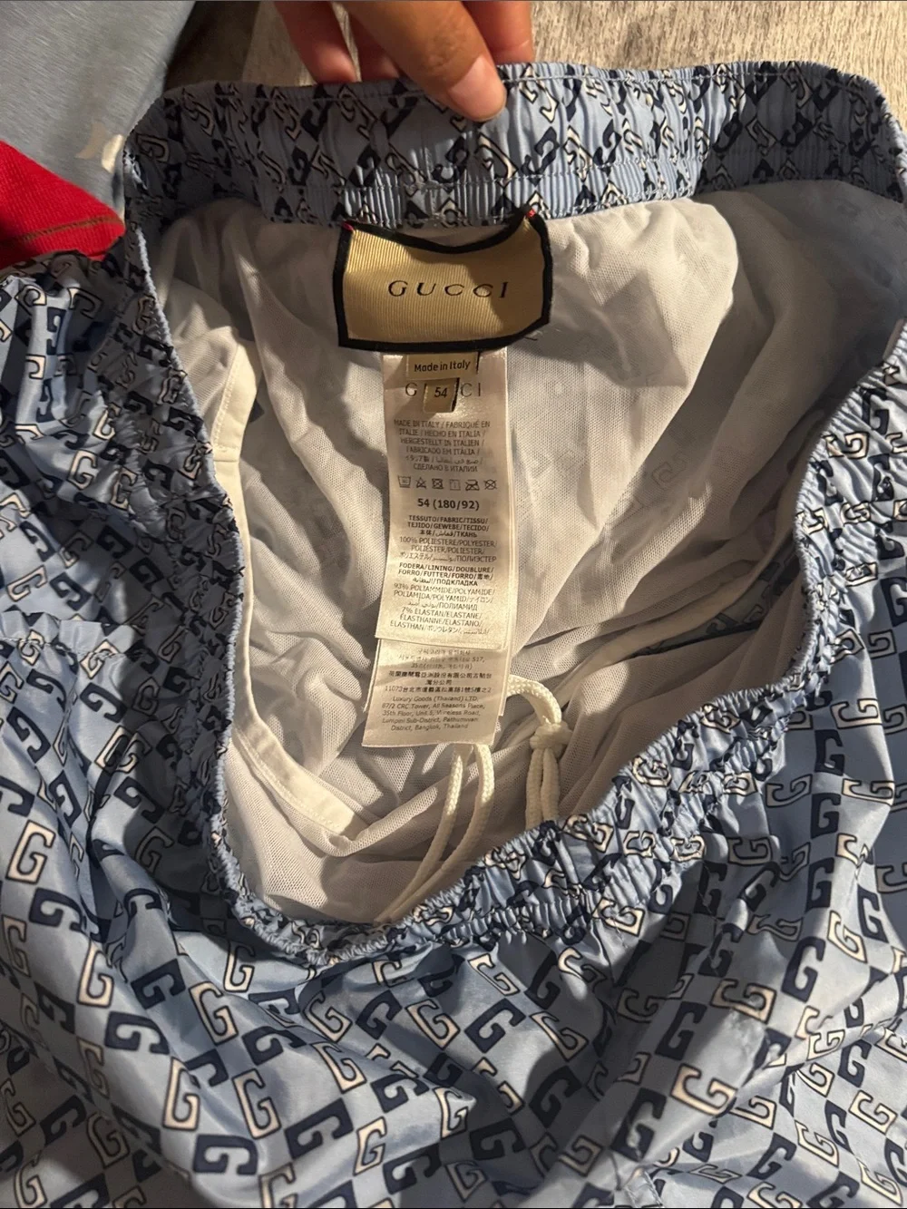 Gucci Men's White and Navy Interlocking G Swim Trunks.